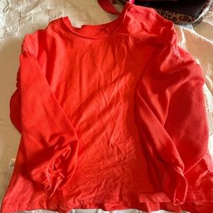 Super cute waffle sleeved sweatshirt in a coral orange color never worn.